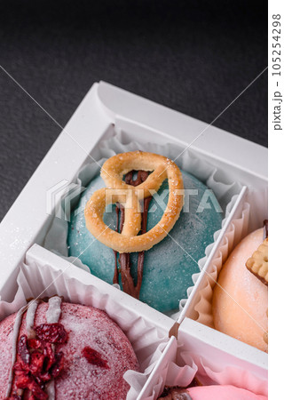 Delicious sweet colorful mochi desserts or ice cream with rice dough and toppings Delicious sweet colorful mochi desserts or ice cream with rice dough and toppings 105254298
