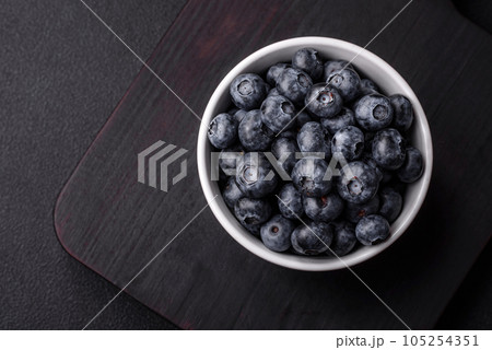 Delicious fresh sweet blueberries in a ceramic bowl. Vegan food 105254351
