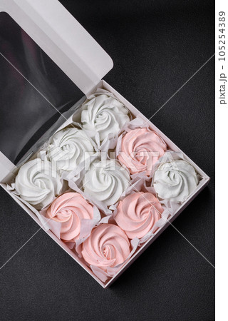 Delicious sweet multi-colored marshmallow on a dark concrete background 105254389