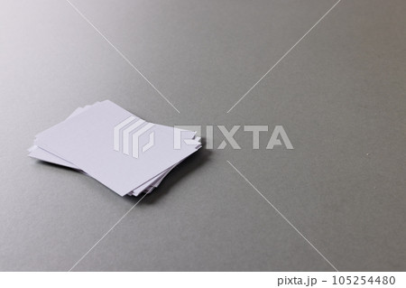 Stack of white business cards with copy space on grey background Stack of white business cards with copy space on grey background 105254480