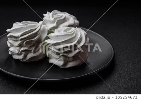 Delicious sweet colored marshmallow on a dark concrete background 105254673
