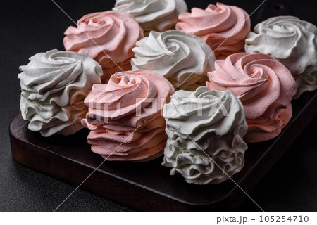 Delicious sweet multi-colored marshmallow on a dark concrete background 105254710