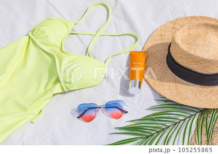 swimming suit, sunglasses and hat on the beach 105255865