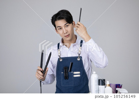 millennials and gen z, korean asian young man grooming his hair millennials and gen z, korean asian young man grooming his hair 105256149