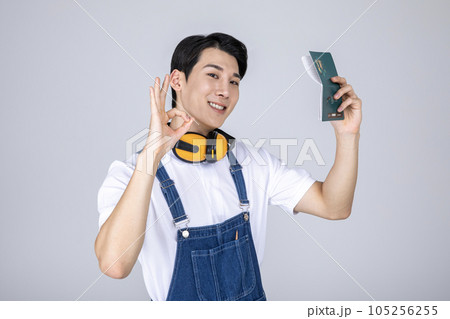 millennials and gen z, korean asian young man carpenter holding a bankbook millennials and gen z, korean asian young man carpenter holding a bankbook 105256255