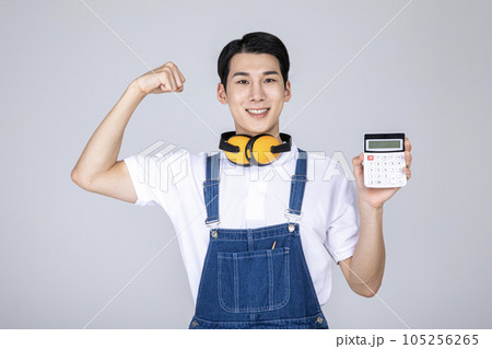 millennials and gen z, korean asian young man carpenter holding a calculator millennials and gen z, korean asian young man carpenter holding a calculator 105256265