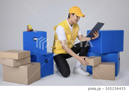 millennials and gen z, korean asian young man working on tablet pc millennials and gen z, korean asian young man working on tablet pc 105256435
