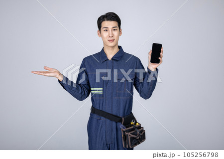 millennials and gen z, korean asian young man, site staff with a smartphone millennials and gen z, korean asian young man, site staff with a smartphone 105256798