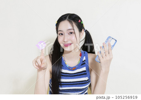 vintage y2k retro decorating a smartphone with stickers 105256919