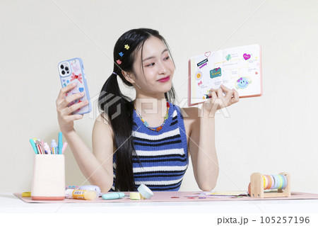 vintage y2k retro concept photo of korean asian cute woman taking selfie of diary decoration with smartphone vintage y2k retro concept photo of korean asian cute woman taking selfie of diary decoration with smartphone 105257196
