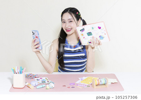 vintage y2k retro concept photo of korean asian cute woman taking selfie of diary decoration with smartphone vintage y2k retro concept photo of korean asian cute woman taking selfie of diary decoration with smartphone 105257306