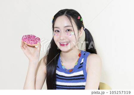vintage y2k retro concept photo of korean asian cute woman with donut 105257319