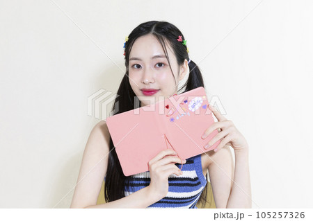 vintage y2k retro concept photo of korean asian cute woman with diary 105257326