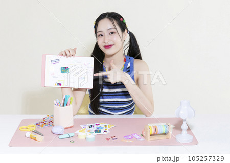 vintage y2k retro concept photo of korean asian cute woman with decorated diary 105257329