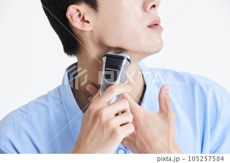 korean asian young man shaving his chin 105257584