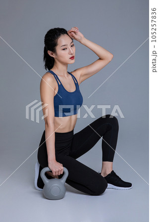healthy beauty concept photo of korean asian beautiful woman with kettlebell 105257836