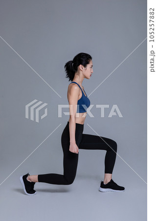 healthy beauty concept photo of korean asian beautiful woman doing squats healthy beauty concept photo of korean asian beautiful woman doing squats 105257882