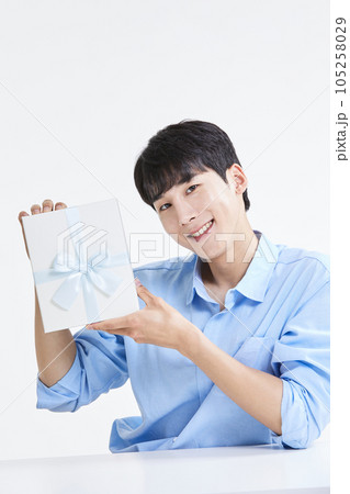 korean asian young man with gift box korean asian young man with gift box 105258029