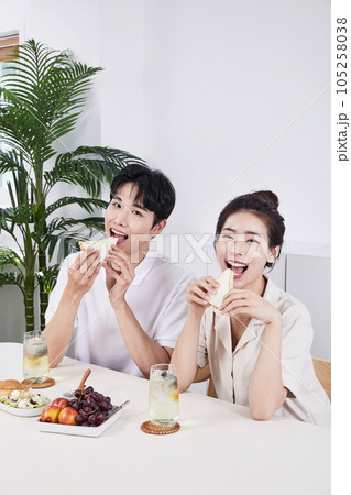 summer lifestyle, korean asian young couple having sandwich summer lifestyle, korean asian young couple having sandwich 105258038