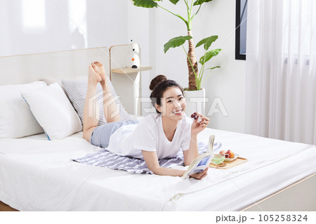 summer lifestyle, korean asian young woman with bed and fruit summer lifestyle, korean asian young woman with bed and fruit 105258324