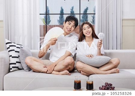 summer lifestyle, korean asian young couple with fan and handheld fan 105258326