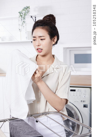 summer lifestyle, korean asian young woman concerned about the smell of laundry 105258348