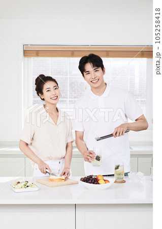 summer lifestyle, korean asian young couple cooking in kitchen summer lifestyle, korean asian young couple cooking in kitchen 105258418