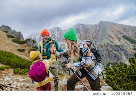 Happy family hiking together in autumn mountains. Happy family hiking together in autumn mountains. 105258864