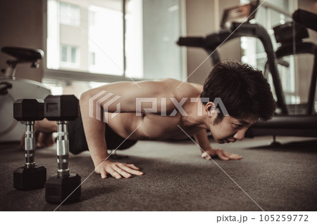 Fitness Workout in the Gym - Bodybuilder Doing Sit-Up Exercises for Abdominal Muscles, Abdominal Muscles with Sit-Up Exercises in Gym, Building Abdominal Muscles with Sit-Up Exercises. Fitness Workout in the Gym - Bodybuilder Doing Sit-Up Exercises for Abdominal Muscles, Abdominal Muscles with Sit-Up Exercises in Gym, Building Abdominal Muscles with Sit-Up Exercises. 105259772
