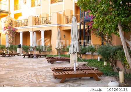 View of the pool, palm trees and the reflection of the sun on the castle grounds in Egypt - the concept of a luxury trip. 105260138
