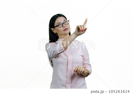 Young smart asian woman is touching invisible virtual screen with her finger. Isolated on white background. 105261614