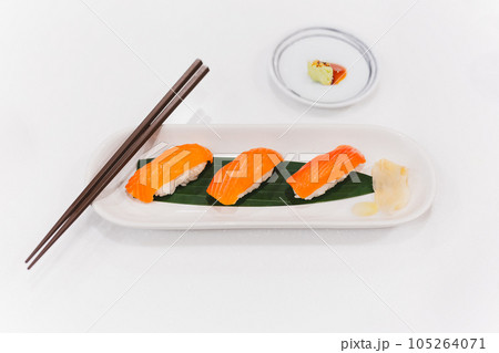 Salmon shushi roll and wasabi shoyu sauce with chopsticks. Salmon shushi roll and wasabi shoyu sauce with chopsticks. 105264071