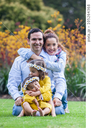 Family of four having fun outdoors in a beautiful sunny day at the park. Happiness concept. Family concept. 105264368