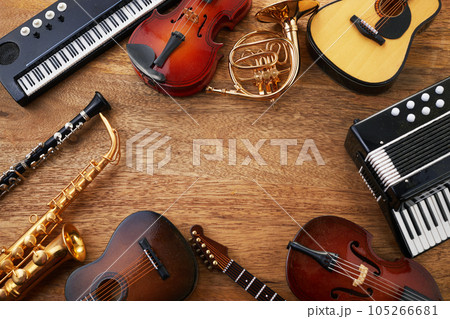 Frame of different musical instruments on wooden background Frame of different musical instruments on wooden background 105266681