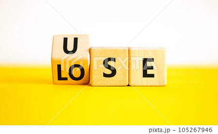 Use or lose symbol. Concept words Use or lose on wooden cubes. Businessman hand. Beautiful yellow table white background. Business Use or lose concept. Copy space. 105267946