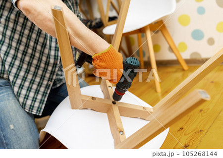 Craftsman collecting with tools, assembling furniture with screwdriver 105268144