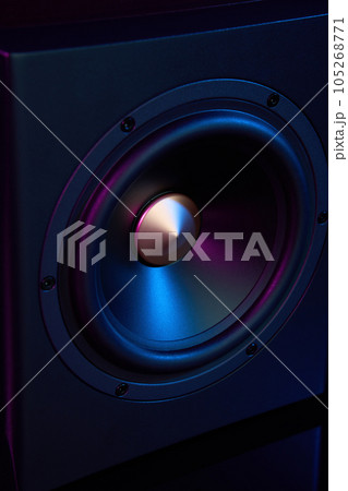 Multimedia acoustic sound speaker with neon lighting. Sound audio system on dark background. Multimedia acoustic sound speaker with neon lighting. Sound audio system on dark background. 105268771
