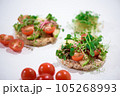 Toasts with microgreens. Hand holds a healthy toast. Healthy food concept. Super food. 105268993