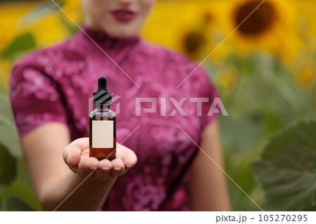 Charming women presenting a natural cosmetic on her hand, mock-up. Copy space. 105270295