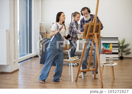 Senior man and females starting art project with dance 105272827