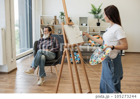 Arts student making initial drawing of older man's portrait Arts student making initial drawing of older man's portrait 105273244