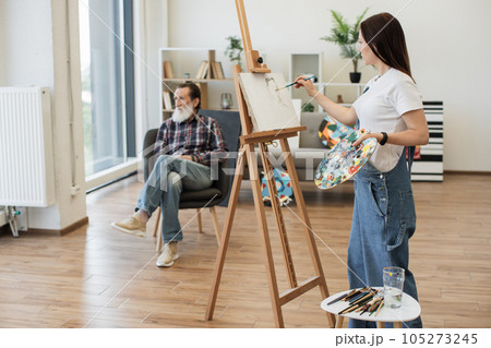 Amateur artist drawing from live senior man in studio space Amateur artist drawing from live senior man in studio space 105273245