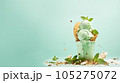 Advertising shot, green nut ice cream with pistachios in a cup top view isolated on light green background. High quality illustration 105275072