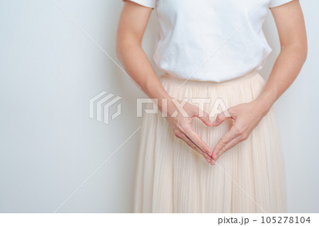 Woman hand heart shape over abdomen. Ovarian and Cervical cancer, Endometriosis, Hysterectomy, Uterine fibroids, Reproductive, menstruation, Stomach, Pregnancy and Sexual Transmitted disease concept Woman hand heart shape over abdomen. Ovarian and Cervical cancer, Endometriosis, Hysterectomy, Uterine fibroids, Reproductive, menstruation, Stomach, Pregnancy and Sexual Transmitted disease concept 105278104