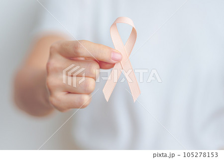 woman holding Peach Ribbon for September Uterine Cancer Awareness month. Uterus and Ovaries, Endometriosis, Hysterectomy, Uterine fibroids, Reproductive, Healthcare and World cancer day concept 105278153