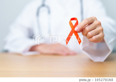 Doctor with Orange Ribbon for Leukemia, Kidney cancer day, world Multiple Sclerosis, CRPS, Self Injury Awareness month. Healthcare and word cancer day concept Doctor with Orange Ribbon for Leukemia, Kidney cancer day, world Multiple Sclerosis, CRPS, Self Injury Awareness month. Healthcare and word cancer day concept 105278168