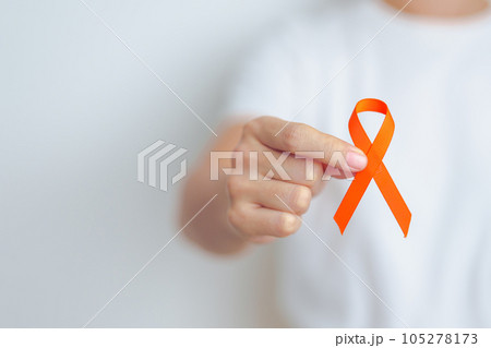 woman with Orange Ribbon for Leukemia, Kidney cancer day, world Multiple Sclerosis, CRPS, Self Injury Awareness month. Healthcare and word cancer day concept woman with Orange Ribbon for Leukemia, Kidney cancer day, world Multiple Sclerosis, CRPS, Self Injury Awareness month. Healthcare and word cancer day concept 105278173