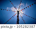 Looking up at bunting flags attached to a pole 105282387