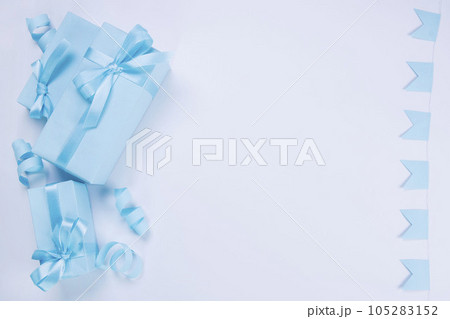 blue gift boxes with blue bows template for copy pasting, postcard, concept for celebrating a boy or man's birthday, party, anniversary or newborn. High quality photo blue gift boxes with blue bows template for copy pasting, postcard, concept for celebrating a boy or man's birthday, party, anniversary or newborn. High quality photo 105283152