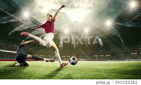 Motivated young women, football, soccer players during match, game, hitting ball, scoring winning goal. 3d arena, sports field Motivated young women, football, soccer players during match, game, hitting ball, scoring winning goal. 3d arena, sports field 105283262